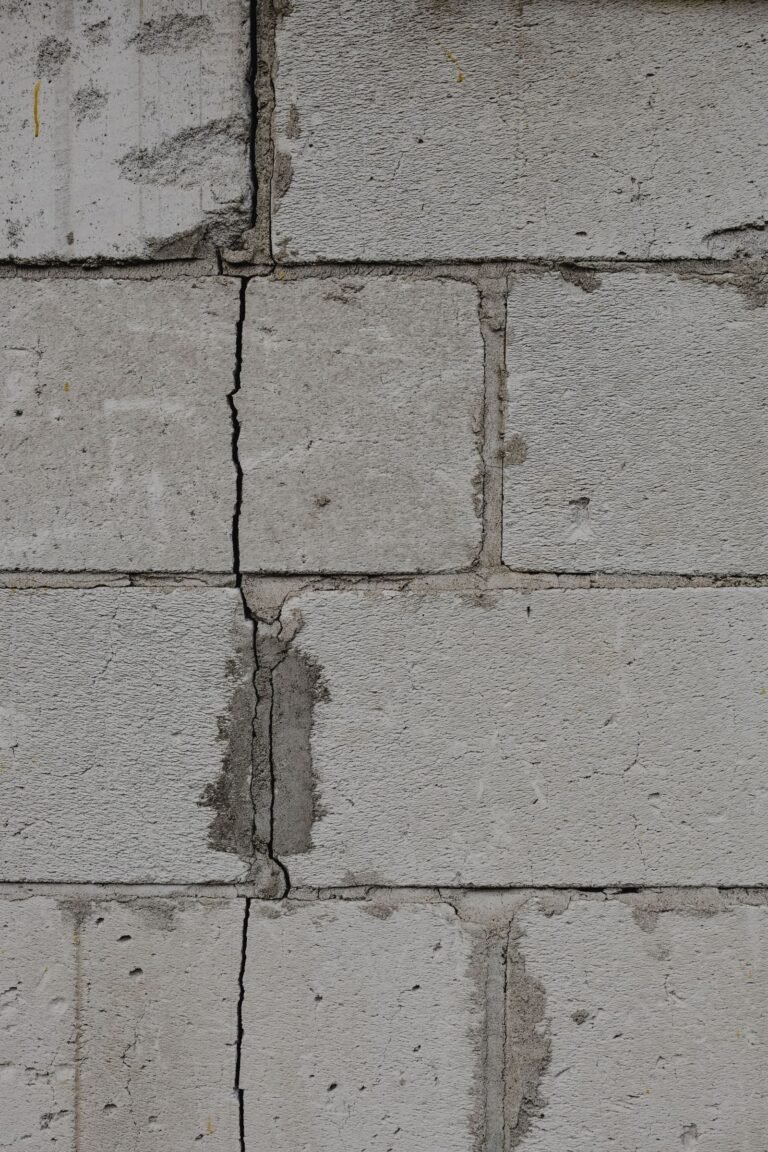 Vertical crack in a concrete block foundation wall, sealed with mortar, in a basement in the Montreal area